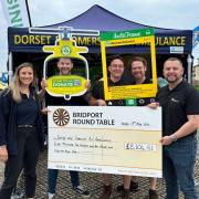 Members of the Bridport Round Table with the cheque for Dorset and Somerset Air Ambulance