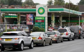 Vehicles queue up outside a BP petrol station Picture: Andrew Matthews/PA