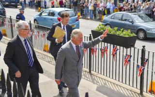 Prince Charles waves to the crowds in East Street on his visit to the Bridport Literary Scientific Institute.   25th May 2018.